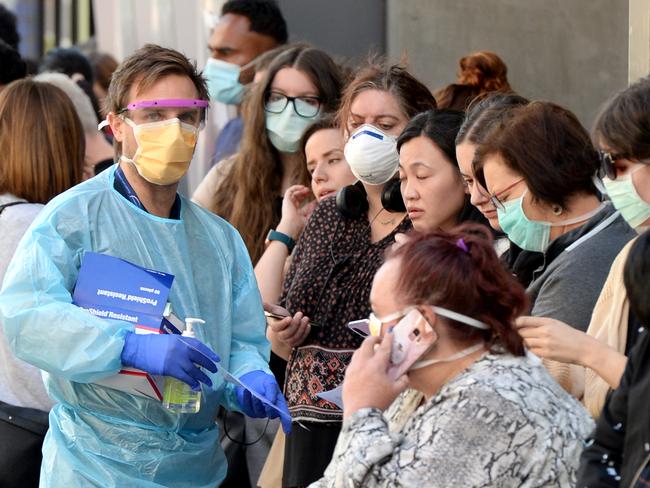 People queue outside the Royal Melbourne Hospital waiting to be be tested for the Coronavirus. Picture: Andrew Henshaw