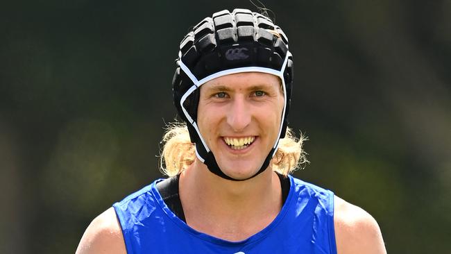 A smiling Aaron Naughton trained in a helmet on Monday after surgery on his cheekbone. Picture: Michael Klein.