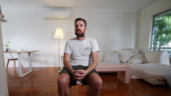 Dan Norris at his Labrador home: “I was on top of the world. Now I walk to the Labrador shops, in stupid oversized shorts I got on special.” Picture: Annette Dew