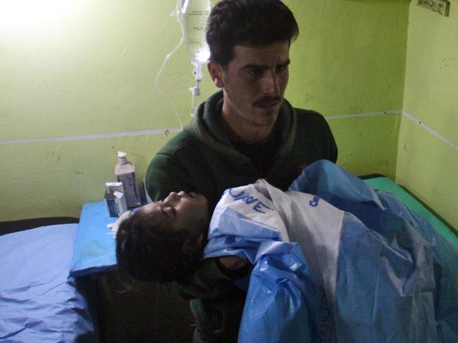 An unconscious child receives help at a hospital in Khan Sheikhun, a rebel-held town in the northwestern Syrian Idlib province, following a suspected toxic gas attack. Picture: Omar haj Kadour/AFP