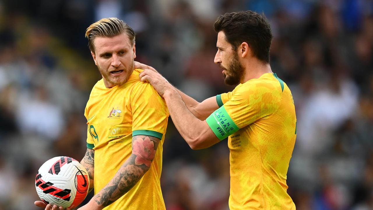 Jason Cummings of the Socceroos prepares to kick a penalty with Mathew Leckie of the Socceroos.