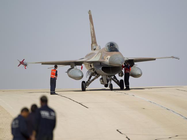 FILE - In this Monday, Nov 25, 2013, file photo, technicians inspect an Israeli air force F-16 jet at the Ovda airbase near Eilat, southern Israel. The Israeli military says it has shot down an Iranian drone that infiltrated the country and has struck Iranian targets in Syria that launched it. The military says that as part of the unusual event one of its F-16 jets crashed in northern Israel. (AP Photo/Ariel Schalit, File)