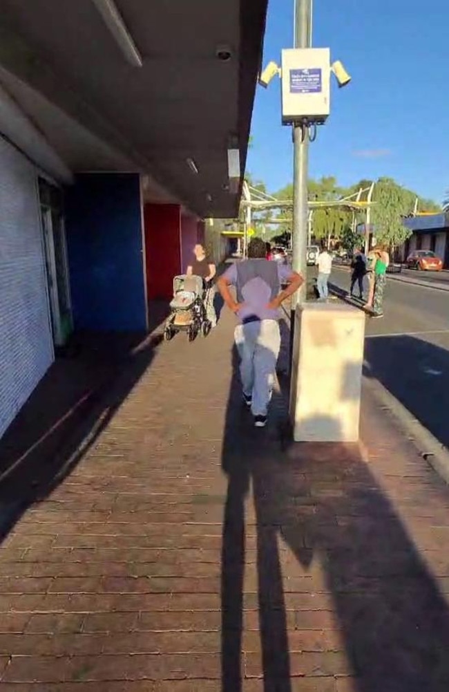 The allegedly armed man walks towards the mum and baby.