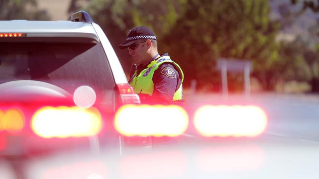 A police officer pulls over a car on the Midland Highway at Bagdad.. Picture: RICHARD JUPE