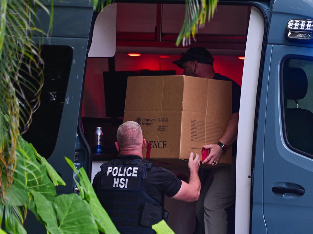 Homeland Security Investigation agents load a box into a car at the entrance of Sean Combs' home at Star Island in Miami Beach in March. Picture: AFP