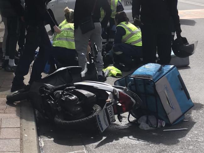 A scooter deliver rider suffered a badly broken leg in a collision with a car driven by a rideshare driver on East Esplanade, Manly, on Wednesday, October 2, 2024.