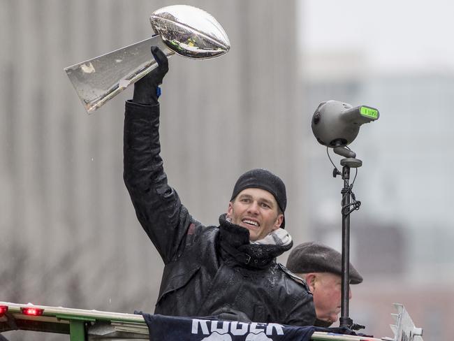 Among Obama’s haul of gifts was a replica of the Vince Lombardi trophy. Pictured is the real deal, wielded by New England Patriots quarterback Tom Brady. Picture: Billie Weiss