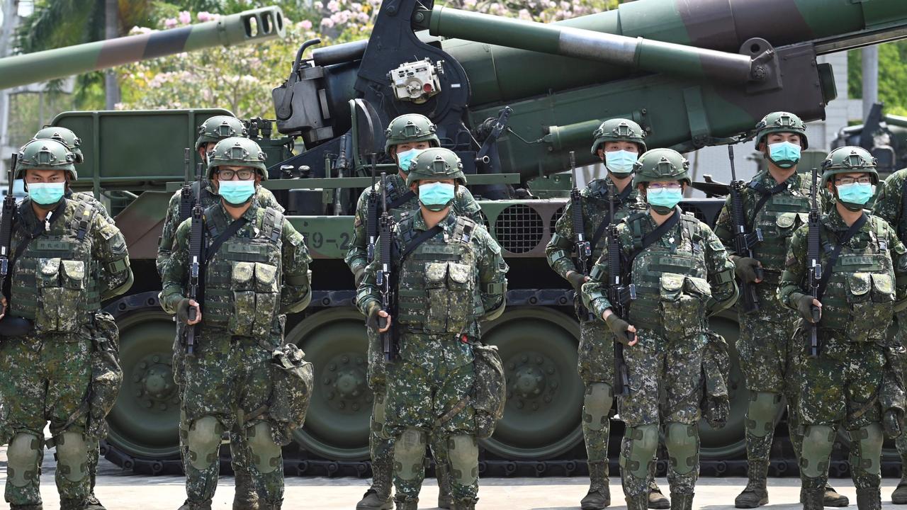 Taiwanese soldiers stand in formation in front of a US-made M110A2 self-propelled howitzer during Taiwan President Tsai Ing-wen's visit to a military base in Tainan, southern Taiwan. Picture: Sam Yeh/AFP