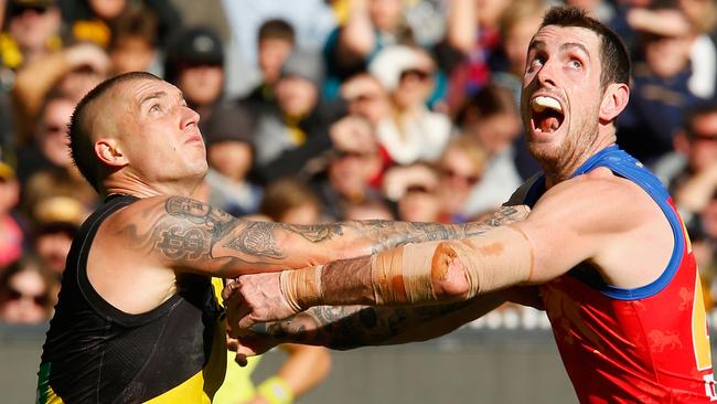 Dustin Martin wrestles with Lion Darcy Gardiner. Pic: Getty Images