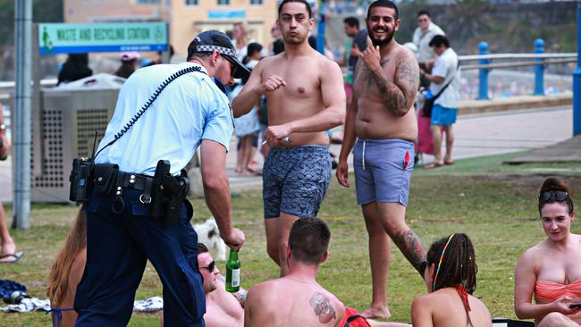 Police enforcing the alcohol ban at Coogee Beach. Picture: Adam Yip