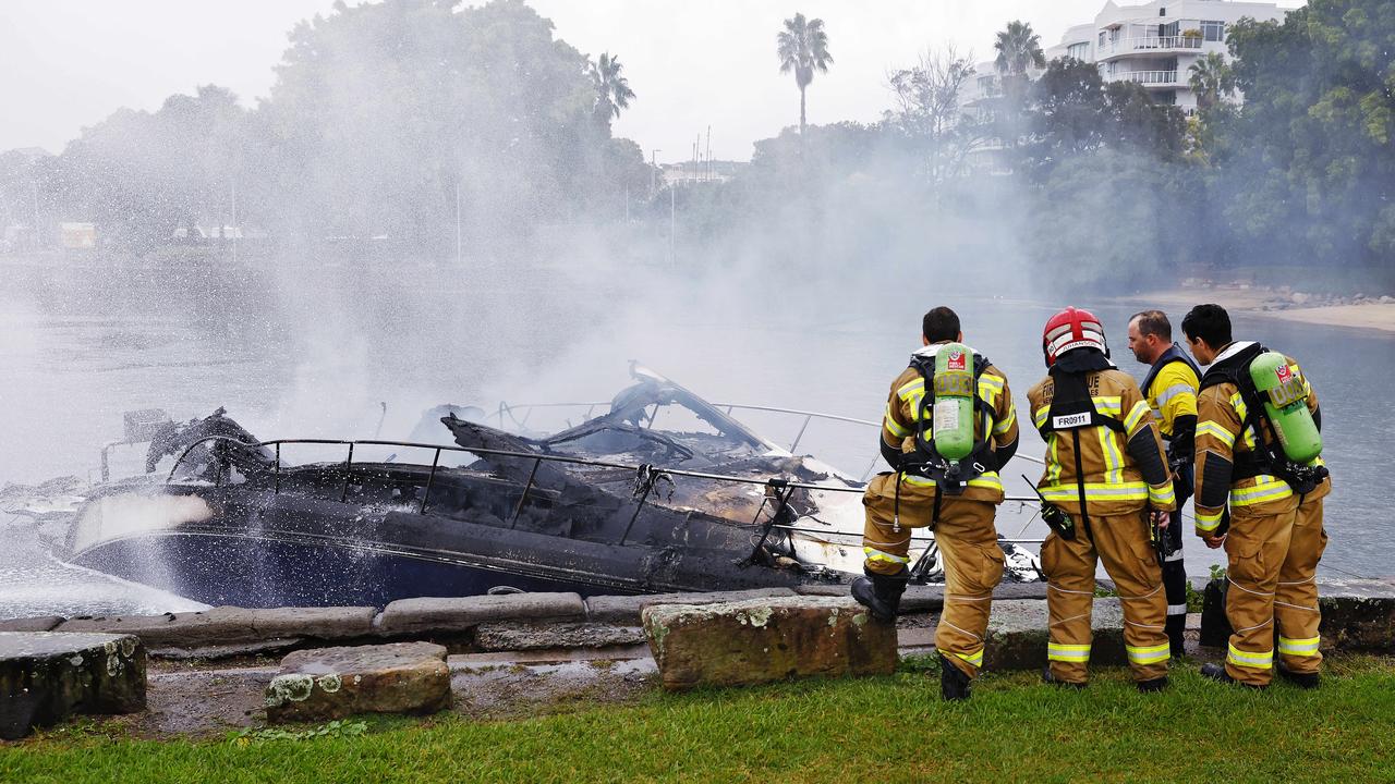 Firefighters check out the smoldering ruins at Birkenhead Point. Picture: Sam Ruttyn