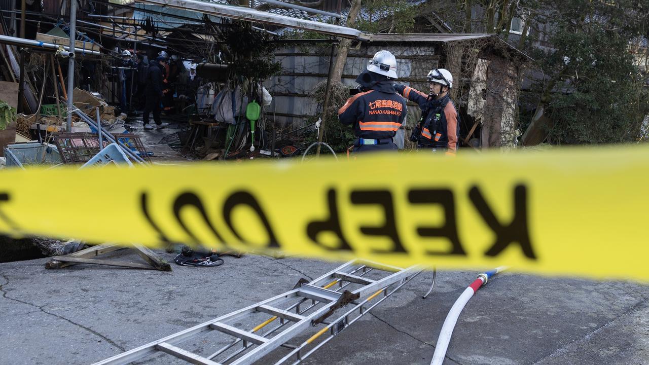 Firefighters investigate a partly burned and collapsed house on January 02, 2024 in Nanao, Japan. Picture: Getty Images