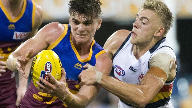 Hard at it: Crow Hugh Greenwood tackles Brisbane’s Ben Keays during his debut game at the Gabba. Picture: Glenn Hunt (AAP).