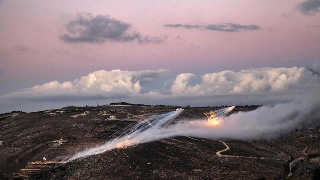 Artillery fire from an Israeli position hits the hills near the outskirts of the border town of Odaisseh in southern Lebanon. Picture: AFP