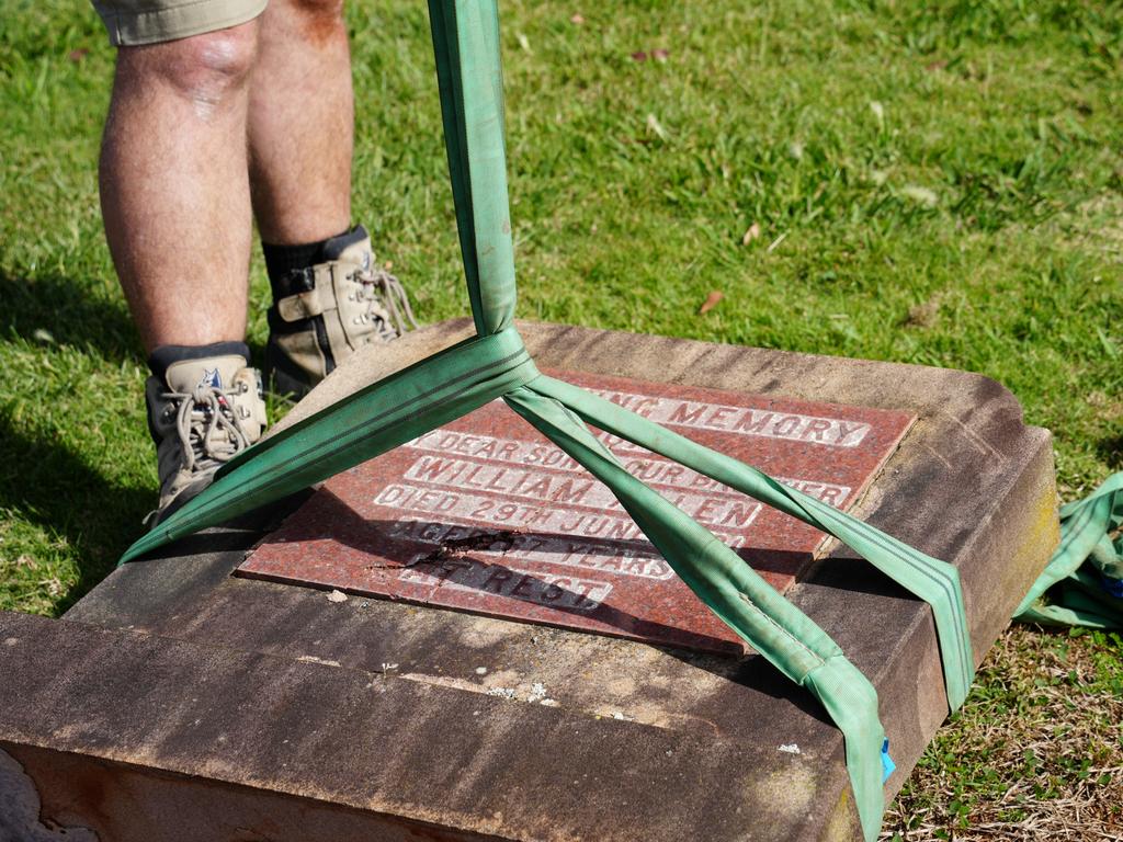 Michael Wagner working to restore the gravestones in Drayton Cemetery that were vandalised last year, as part of the Headstone Healing Project.