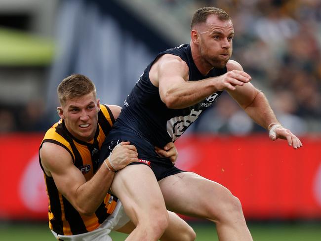 Sam Docherty is wrapped up by Dylan Moore. Picture: Michael Willson/AFL Photos via Getty Images