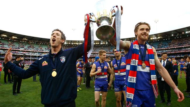 Bob Murphy and Jordan Roughead hold the premiership cup aloft.