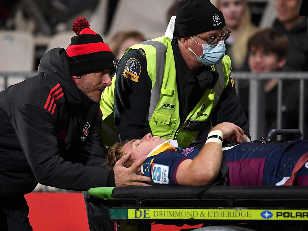 Reds halfback Tate McDermott leaves the field om a medi-cab after copping a head knock. Picture: Sanka Vidanagama / AFP
