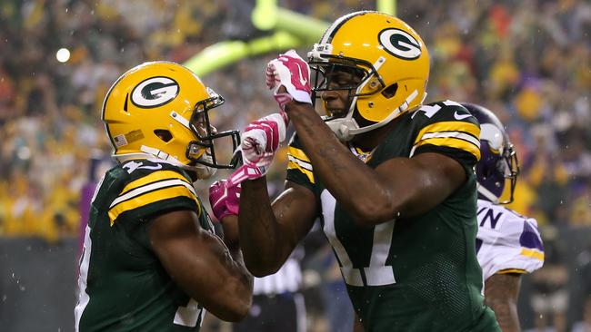 Davante Adams #17 and Randall Cobb #18 of the Green Bay Packers celebrate after Cobb's eight-yard touchdown run.