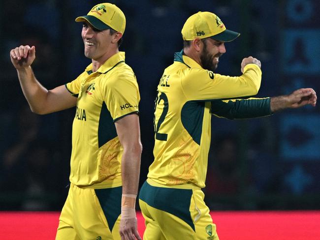 Australia's captain Pat Cummins (L) and Glenn Maxwell celebrate after the dismissal of Netherlands' Vikramjit Singh. Picture: AFP