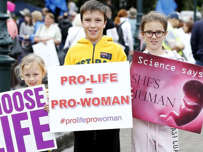 Amelia, 5, Joshua, 10 and Alyssa Balantyne (8) posing at the Cherish Life, Rally for Life rally outside Parliament House, Brisbane 13th of October 2018.  They're rallying to protest the late-term abortion bill.  (AAP Image/Josh Woning)