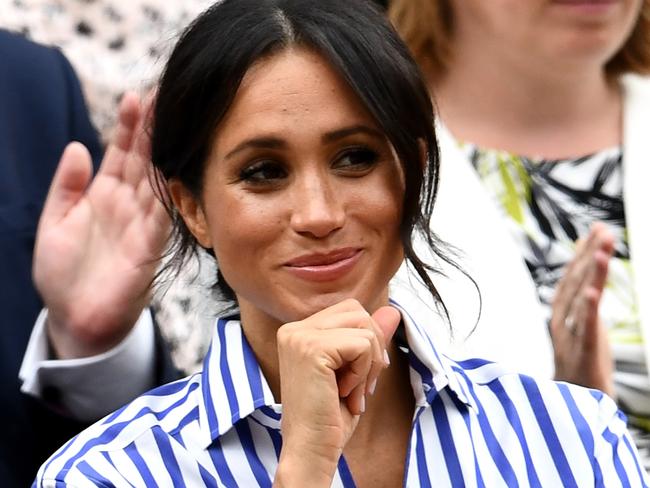 Meghan, Duchess of Sussex wore a blue and white striped shirt with white pants. Picture: Clive Mason/Getty Images.