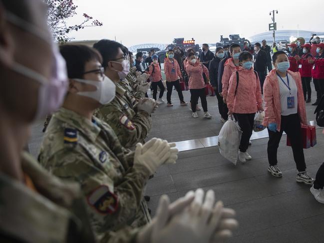 In this March 18, 2020 photo released by China's Xinhua News Agency, people applaud as departing medical workers enter Wuhan Tianhe International Airport in Wuhan in central China's Hubei Province. Last month, Wuhan was overwhelmed with thousands of new cases of coronavirus each day. But in a dramatic development that underscores just how much the outbreak has pivoted toward Europe and the United States, Chinese authorities said Thursday that the city and its surrounding province had no new cases to report. The virus causes only mild or moderate symptoms, such as fever and cough, for most people, but severe illness is more likely in the elderly and people with existing health problems. (Ke Hao/Xinhua via AP)