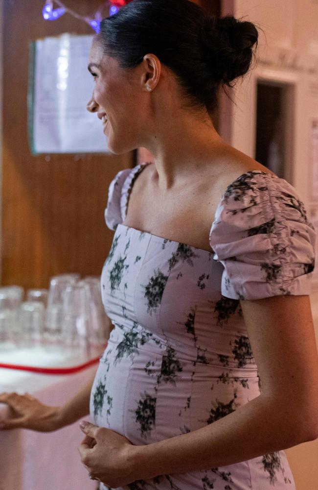 The Duchess cradling her bump at the Royal Variety Charity's residential nursing and care home in Twickenham. Picture: AFP 