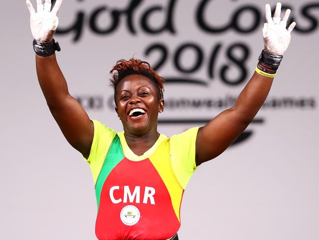 Arcangeline Fouodji Sonkbou of Cameroon waves to the crowd after the Women's 69 kilogram final at Carrara Sports and Leisure Centre. Picture: Mark Kolbe/Getty Images