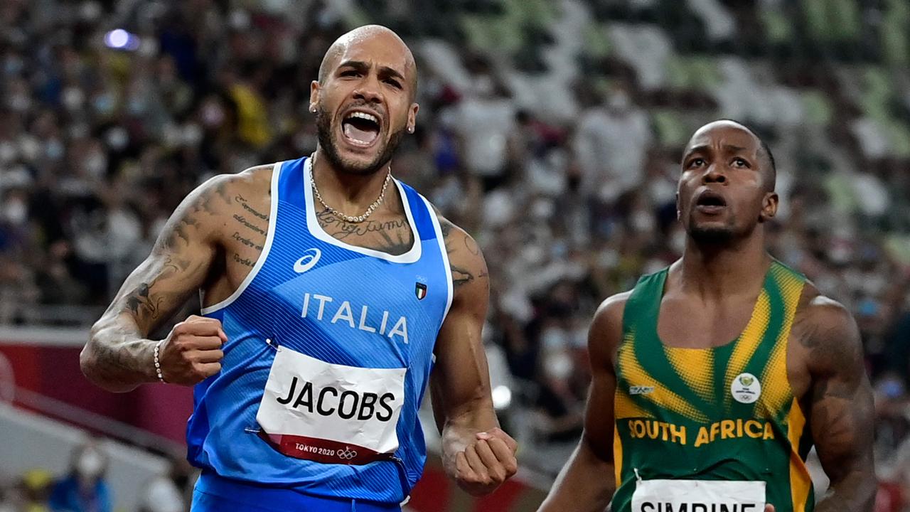 Italy's Lamont Marcell Jacobs (L) wins the men's 100m final.