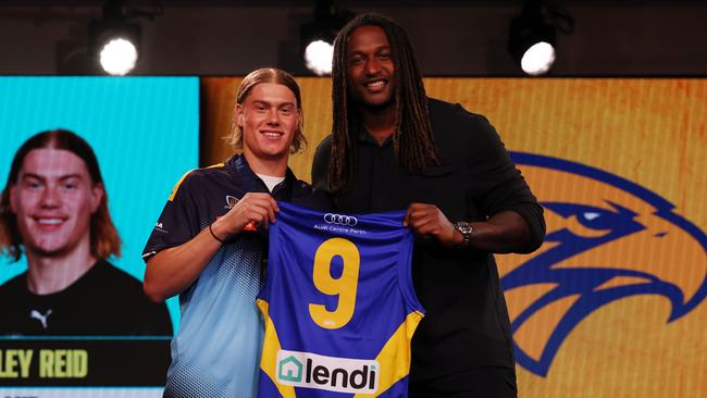 Pick 1 Harley Reid receives his jumper from Nic Naitanui. Pic: Michael Klein