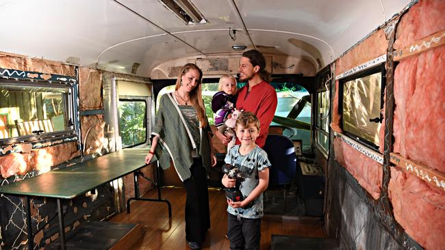 NEW HOME: Tanawha family purchased an old bus to renovate as a travelling home. Michael and Anneli Verity with Aurelia, 2, and Mylo Saultry, 7, inside the bus. Picture: Warren Lynam