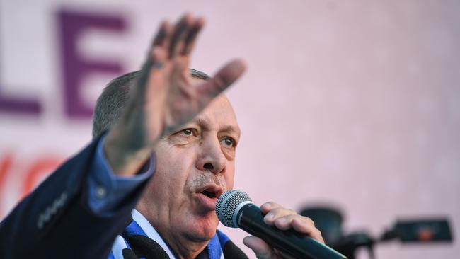 Turkish President Recep Tayyip Erdogan sings his election song before delivering a speech at an election rally in Istanbul's Kasimpasa district, on March 5, 2019. - Turkish leader is picking up the microphone to croon, complete with hand gestures, as he campaigns for March 31 ballot to rally supporters for his ruling AKP party.Music has always been a powerful tool in Turkish politics but with Erdogan and his Justice and Development Party (AKP), it has become an indispensible weapon. (Photo by Ozan KOSE / AFP)