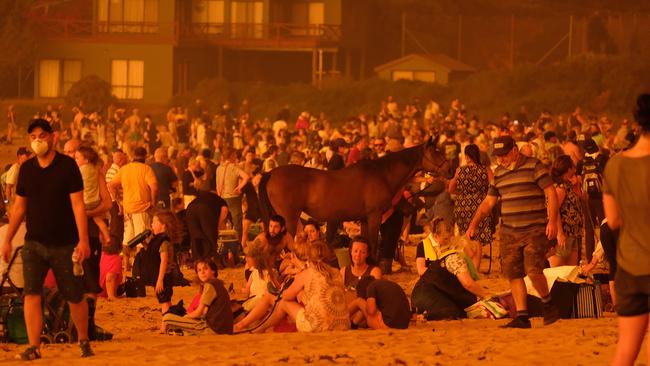 People crowded the beach at Malua Bay as fire approached the township on New Year’s Eve. Picture: Alex Coppel