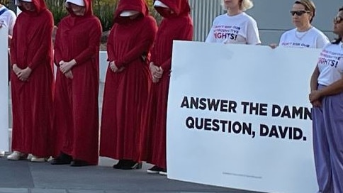 Protesters gather outside the venue for the Sky News/Courier-Mail People's Forum in Brisbane.