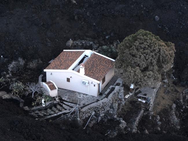 Incredible images show homes buried in ash