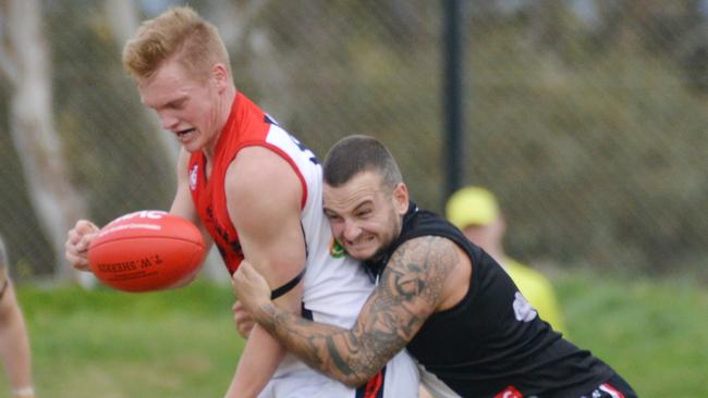 Flagstaff Hill’s Casey Davies is tackled by Christies Beach’s Rhys Mundy. Flaggies prevailed in the qualifying final against the Saints and will now play Noarlunga for a spot in the SFL grand final. Picture: AAP/Brenton Edwards