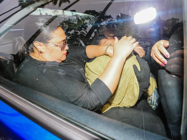 Alo-Bridget Namoa covers her head outside Silverwater prison with her mother and family members. Picture: Craig Greenhill