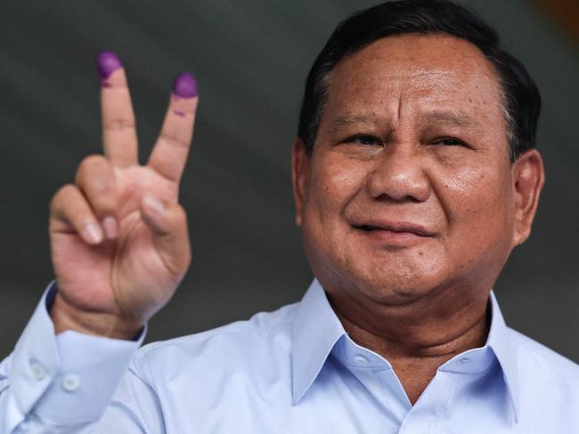 TOPSHOT - Indonesia's presidential candidate Prabowo Subianto gestures after he cast his ballot to vote in the countryâs presidential and legislative elections at a polling station in Bogor on February 14, 2024. Indonesians began voting for a new president on February 14 with Defence Minister Prabowo Subianto the frontrunner to lead Southeast Asia's biggest economy despite concerns over his human rights record. (Photo by Yasuyoshi CHIBA / AFP)