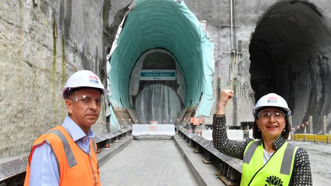 NSW Premier Gladys Berejiklian (right) and Minister for Transport and Roads Andrew Constance (left) watch as a tunnel boring machine breaks through the Metro Rail Tunnel. Picture: AAP Image/Dean Lewins