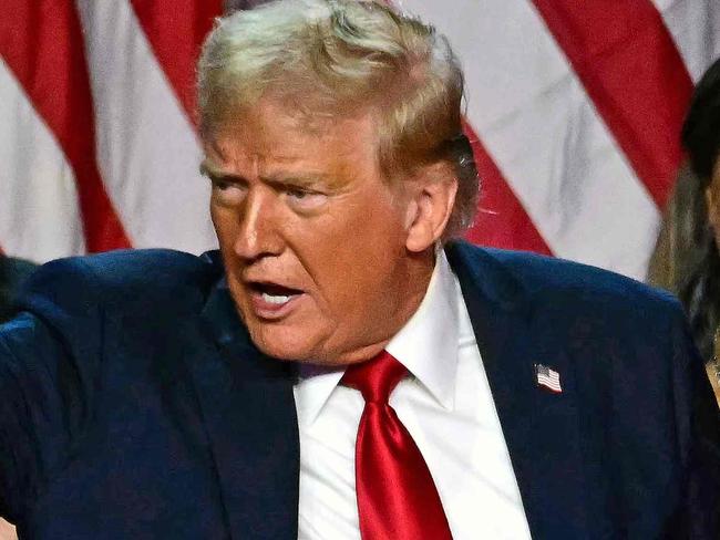 Former US President and Republican presidential candidate Donald Trump gestures at supporters after speaking as he holds hands with former US First Lady Melania Trump during an election night event at the West Palm Beach Convention Center in West Palm Beach, Florida, early on November 6, 2024. Republican former president Donald Trump closed in on a new term in the White House early November 6, 2024, just needing a handful of electoral votes to defeat Democratic Vice President Kamala Harris. (Photo by Jim WATSON / AFP)