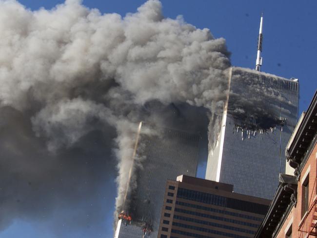 FILE - In this Sept. 11, 2001 file photo, smoke rising from the burning twin towers of the World Trade Center after hijacked planes crashed into the towers, in New York City. Every American of a certain age has a 9/11 story _ vivid memories of where they were, what they saw, how they felt on that awful day. Donald Trump is one of them. And for New Yorkers like him, 9/11 melds first-hand experience with what they felt in their guts, what they saw on television and what was playing out in the lives of friends and loved ones in a city under siege. (AP Photo/Richard Drew, File)