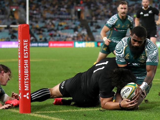 Marika Koroibete of the Wallabies deniesCaleb Clarke of the All Blacks a try. Picture: Cameron Spencer/Getty Images