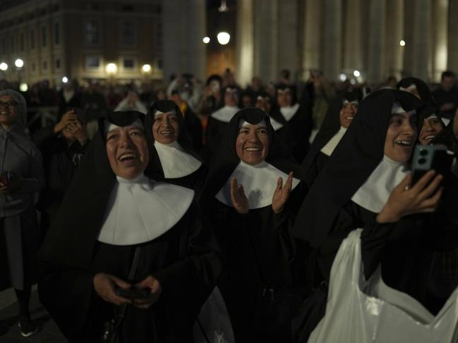 Nuns applaud as black smoke billows from the chimney of the Sistine Chapel during the cardinals' conclave to elect a new pope. Picture: AP