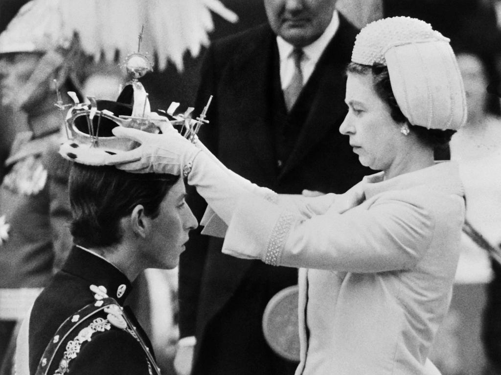 Queen Elizabeth II puts a crown on her son, Prince Charles, during his investiture as new Prince of Wales in Caernarfon. Picture: AFP