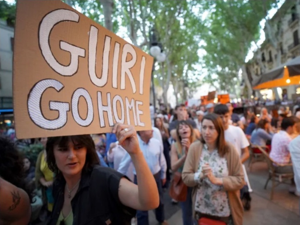 The protesters held up banners with the term ‘Guiri’ written on them – a mildly offensive term for Europeans who visit the park resort of Magaluf. Picture: Solarpix
