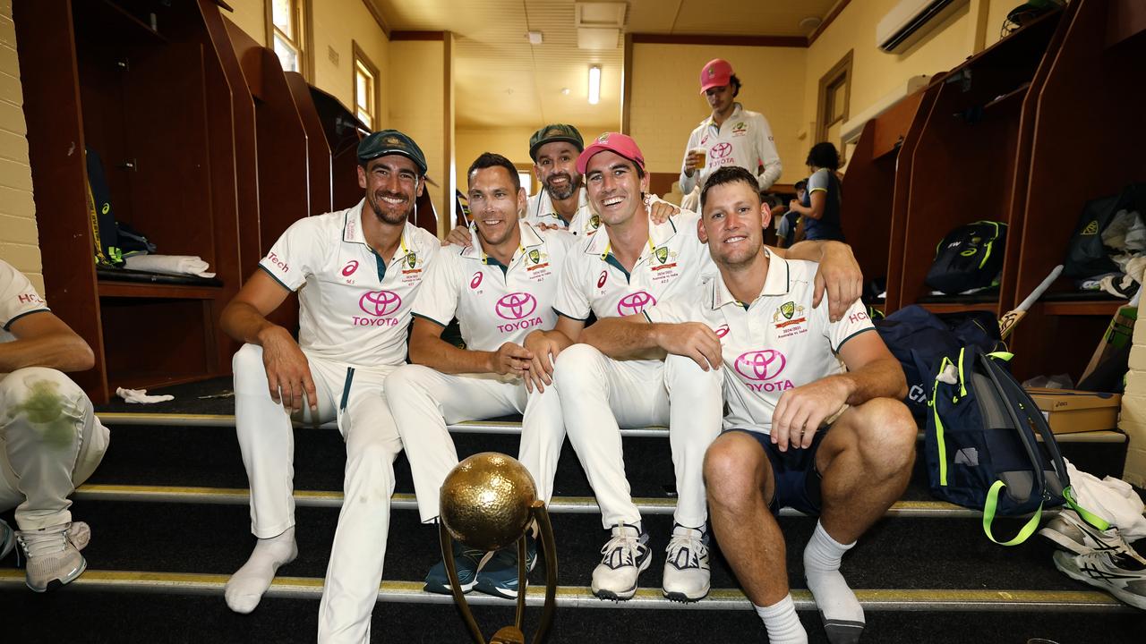 Australia’s bowlers in the SCG dressing room with the Border Gavaskar Trophy. (Photo by Darrian Traynor/Getty Images)