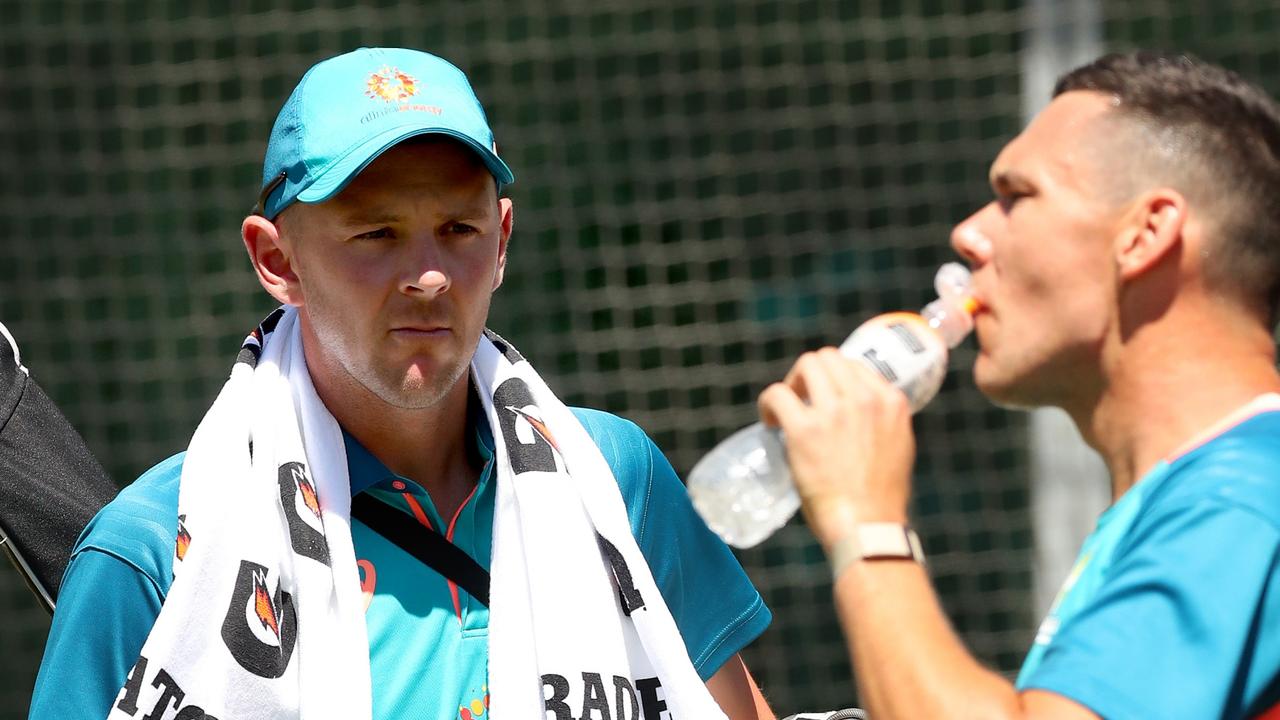 MELBOURNE, AUSTRALIA - DECEMBER 24: Josh Hazlewood of Australia arrives as Scott Boland has a drink during an Australian Test squad training session at Melbourne Cricket Ground on December 24, 2022 in Melbourne, Australia. (Photo by Kelly Defina/Getty Images)