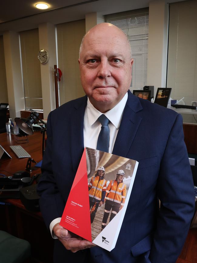 Victorian Treasurer Tim Pallas in his office with the 2023-2024 State Budget report. Picture: David Caird