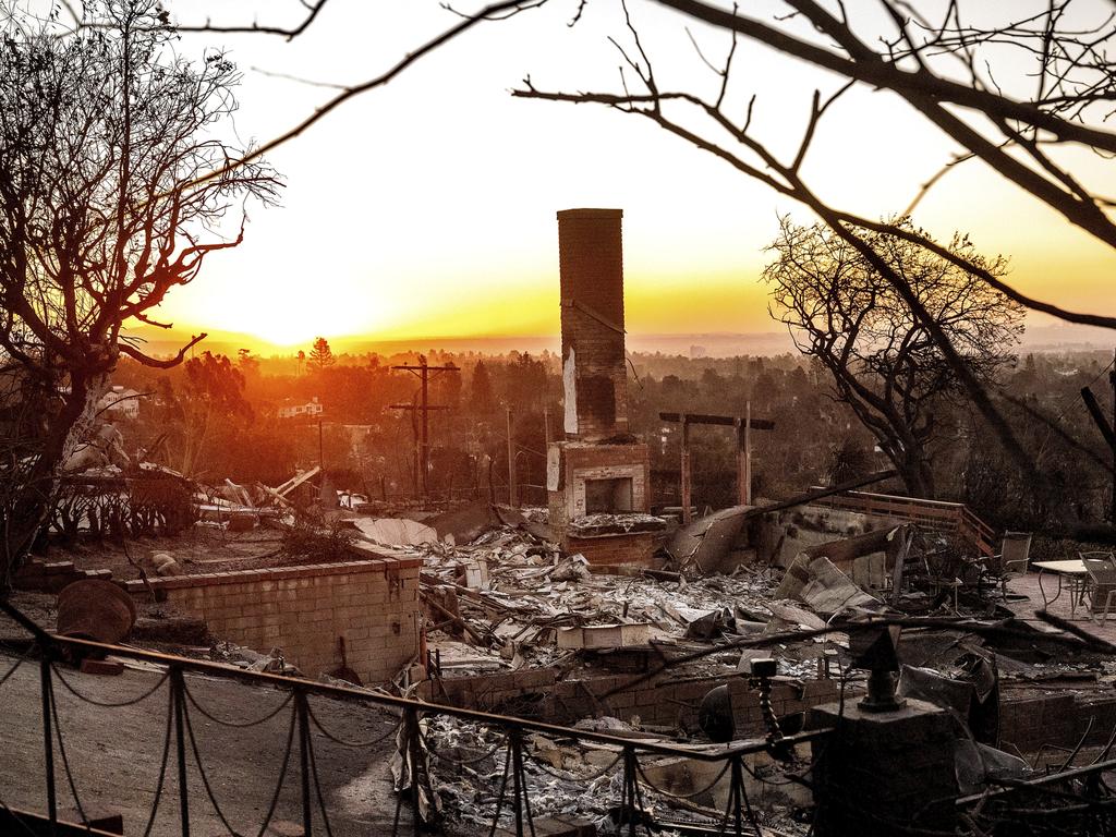 The sun rises behind a home destroyed in the Pacific Palisades. Picture: AP